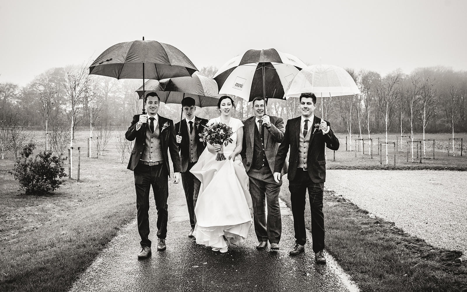 Capture Every Moment wedding photography duo from Cirencester reportage traditional photographers Lapstone Barn Chipping Campden Cotswolds venue Bride Groom Groomsmen Umbrellas shielding from rain