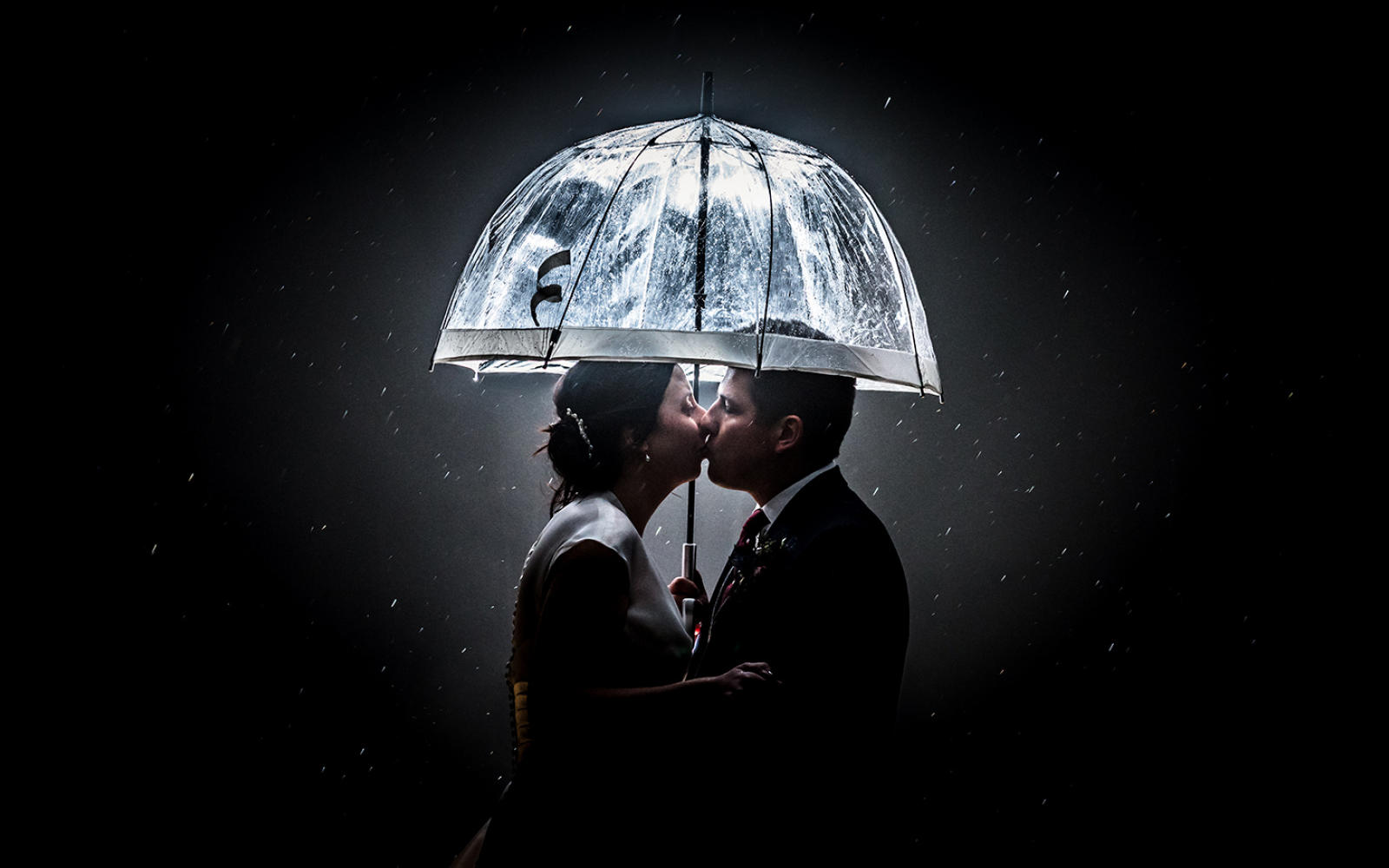 Capture Every Moment wedding photography duo from Cirencester reportage traditional photographers Lapstone Barn Chipping Campden Cotswolds venue Bride Groom kiss under an umbrrella under the stars