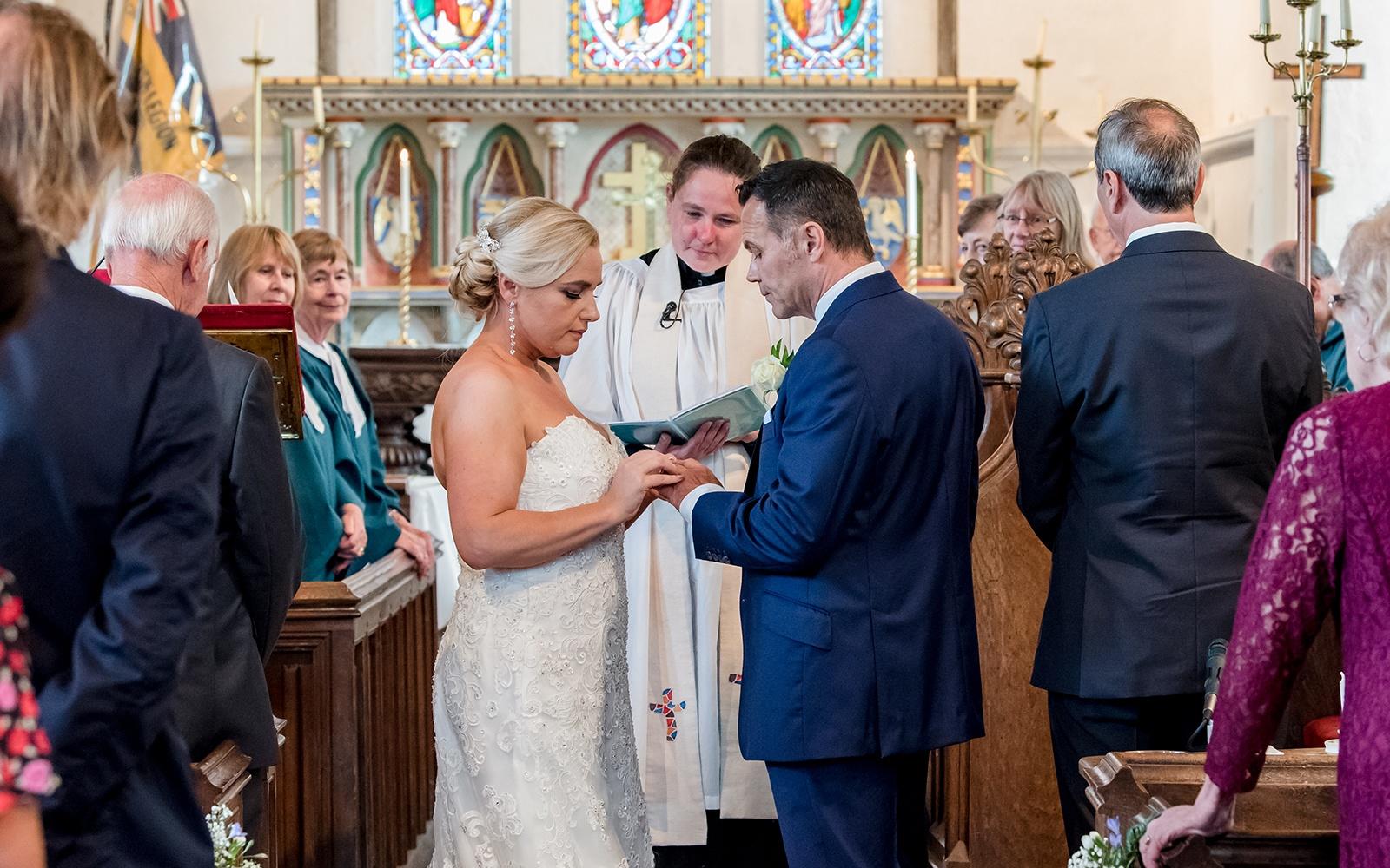 Real Wedding Capture Every Moment Cirencester photography duo wedding photographer giving of the rings church wedding