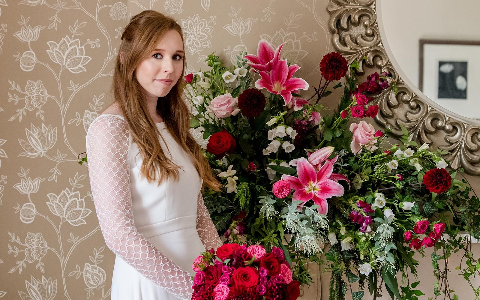 long sleeved bridal gown large floral arrangement 