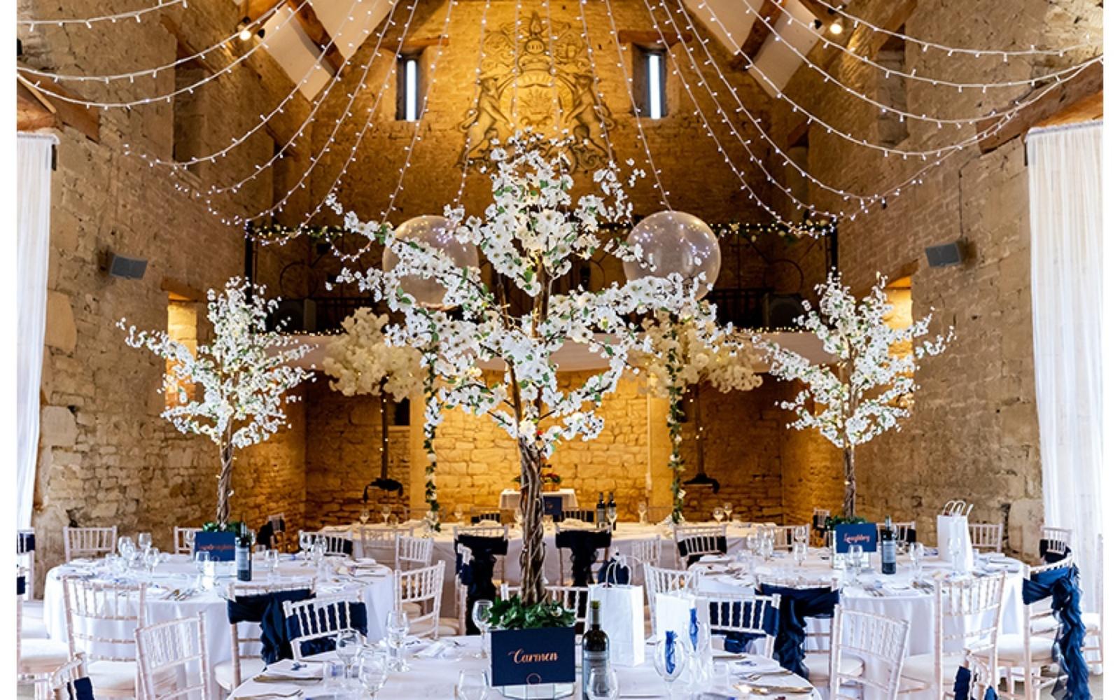 Copper & Blossom Real wedding Photography Wiltshire The Great Tythe Barn Tetbury vaulted barn ceiling blossom tree centre piece