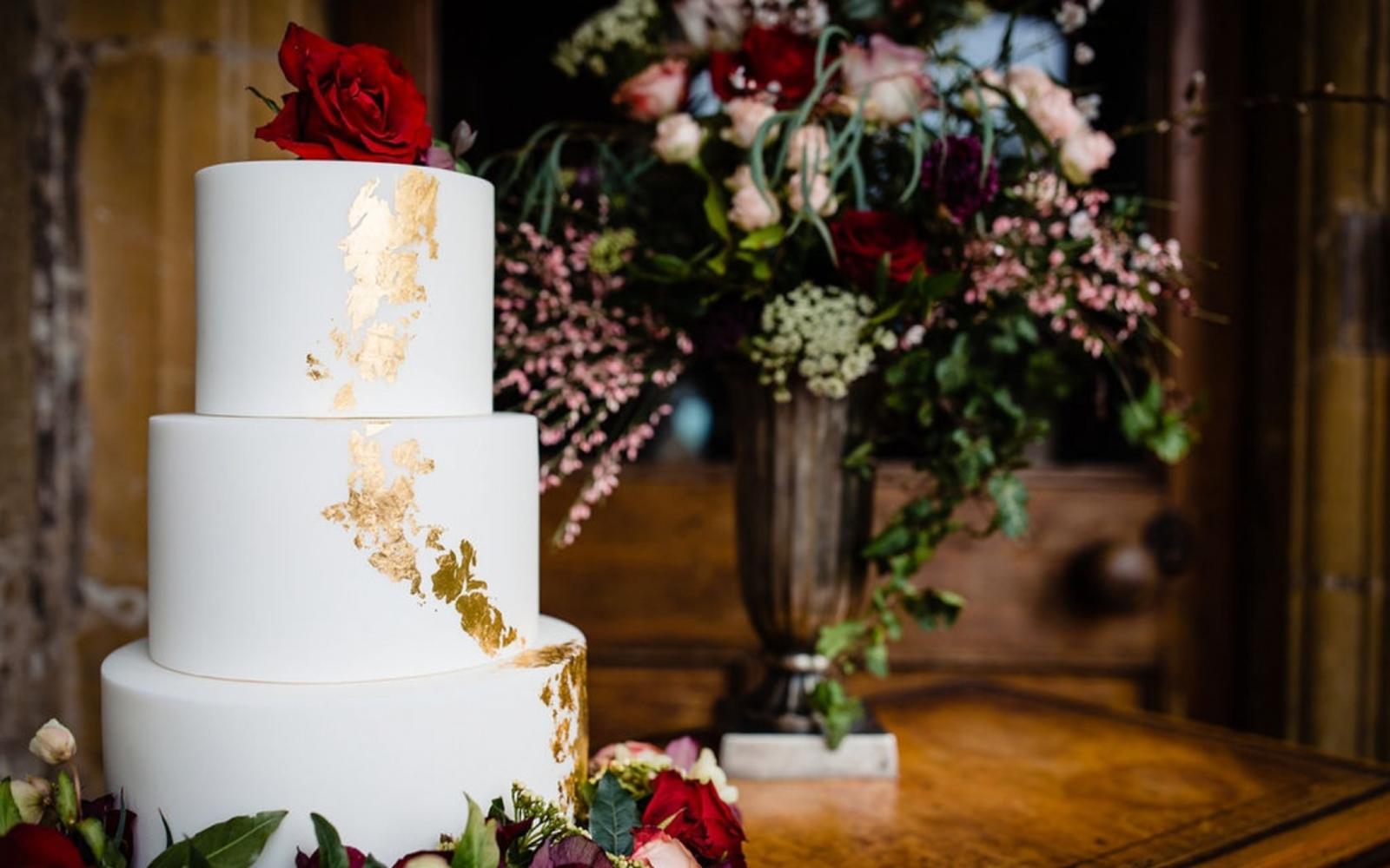three tier wedding cake with gold leaf 