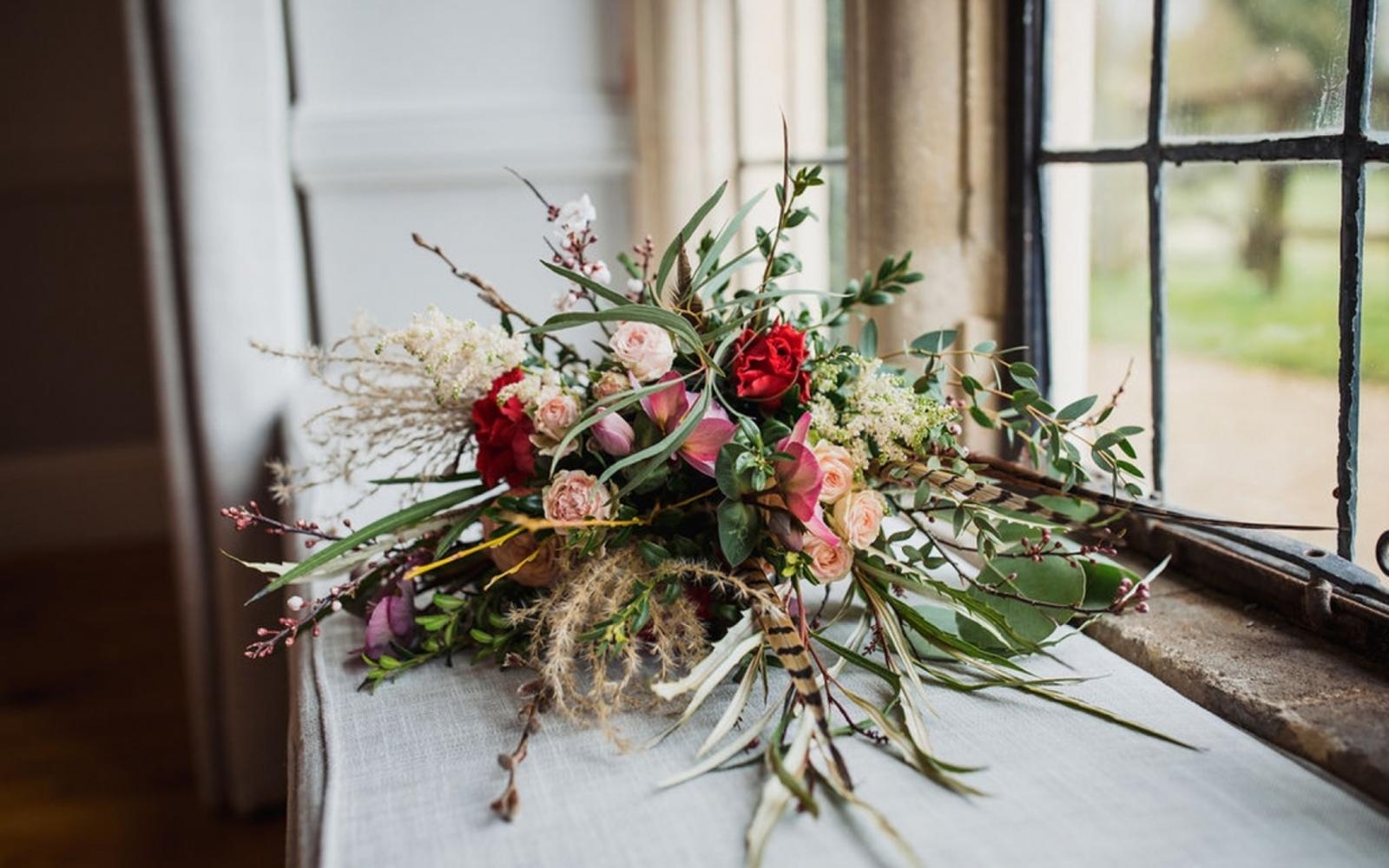 peacock feathers and foliage in bridal bouquet