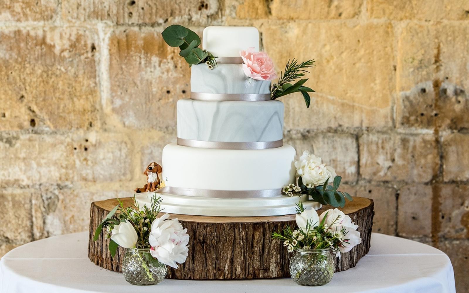 Capture Every Moment wedding photography duo from Cirencester reportage and traditional photographers Lapstone Barn Chipping Campden Cotswolds venue three tiered cake fondant icing champagne ribbon real flowers