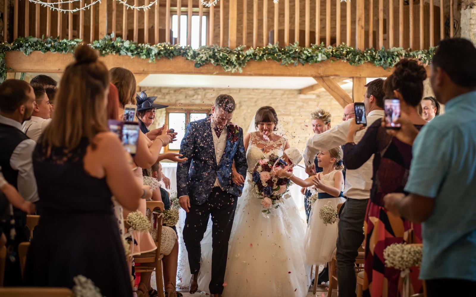 Real Wedding Strike A Pose Photography Wiltshire wedding photographer Kingscote Barn Tetbury Gloucestershire just married confetti shot large glass windows 