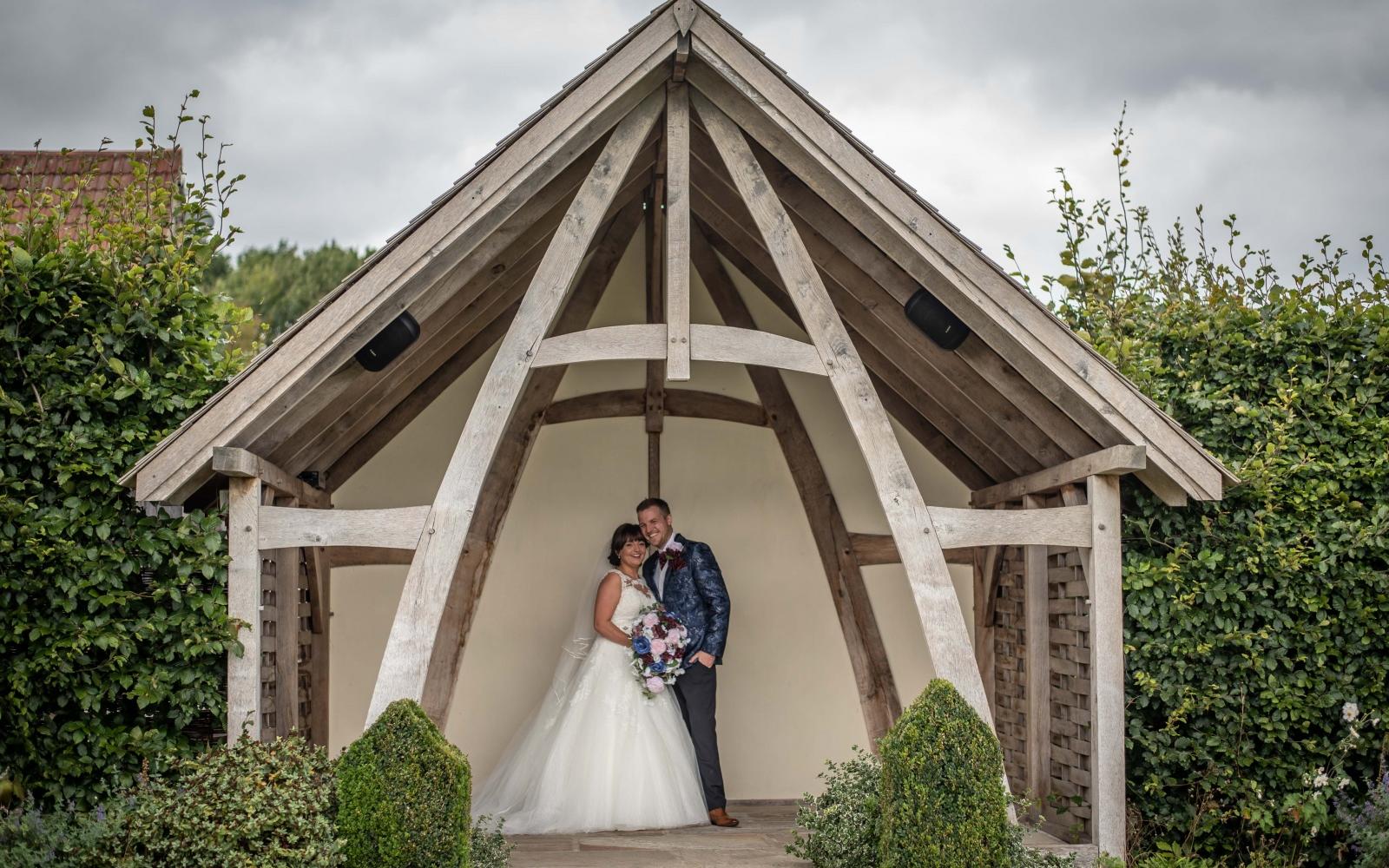 Real Wedding Strike A Pose Photography Wiltshire wedding photographer Kingscote Barn Tetbury Gloucestershire outside oak framed structure posed photo