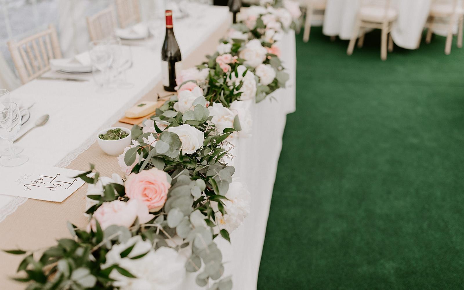 Real wedding Corky and Prince flowers florist stylist Gloucestershire Jenner's Barn Fairford Barn reception head table floral display roses and peonies