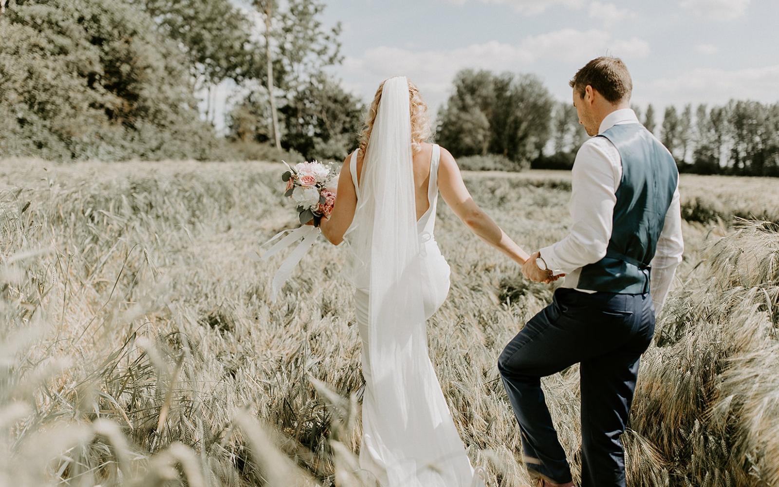 Real wedding Corky and Prince flowers florist stylist Gloucestershire Jenner's Barn Fairford Barn reception bride and groom crop field photograph