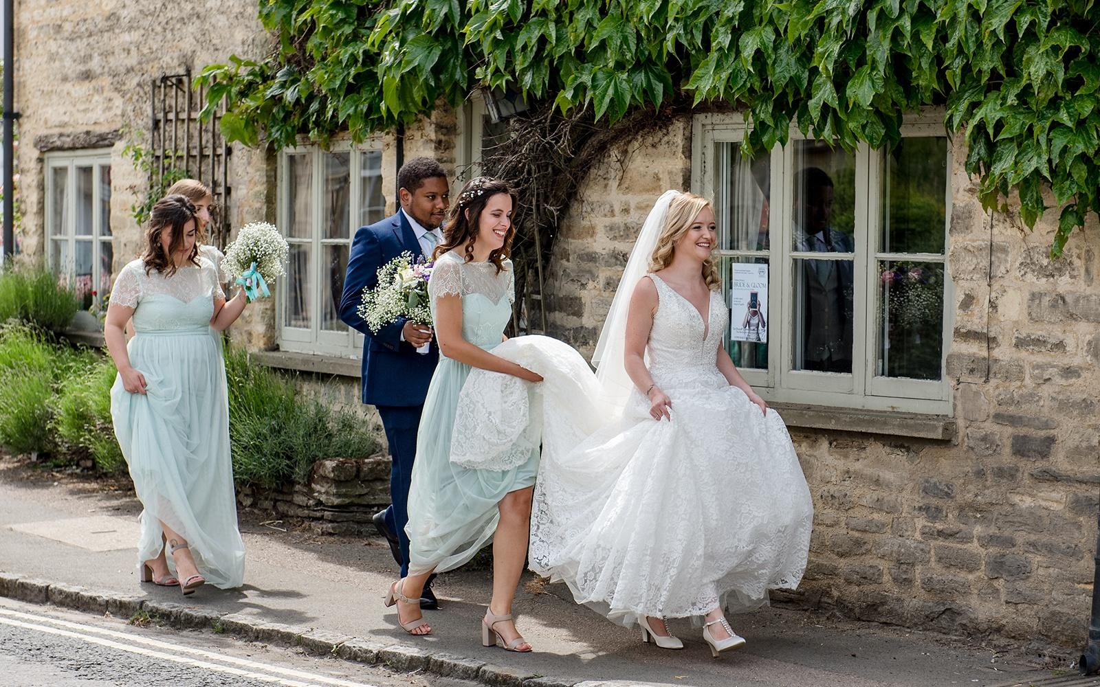 Capture Every Moment real wedding photography duo photographer Cirencester  Church of St Mary The Virgin Bampton Spittleborough Farm Wiltshire walking to the church 