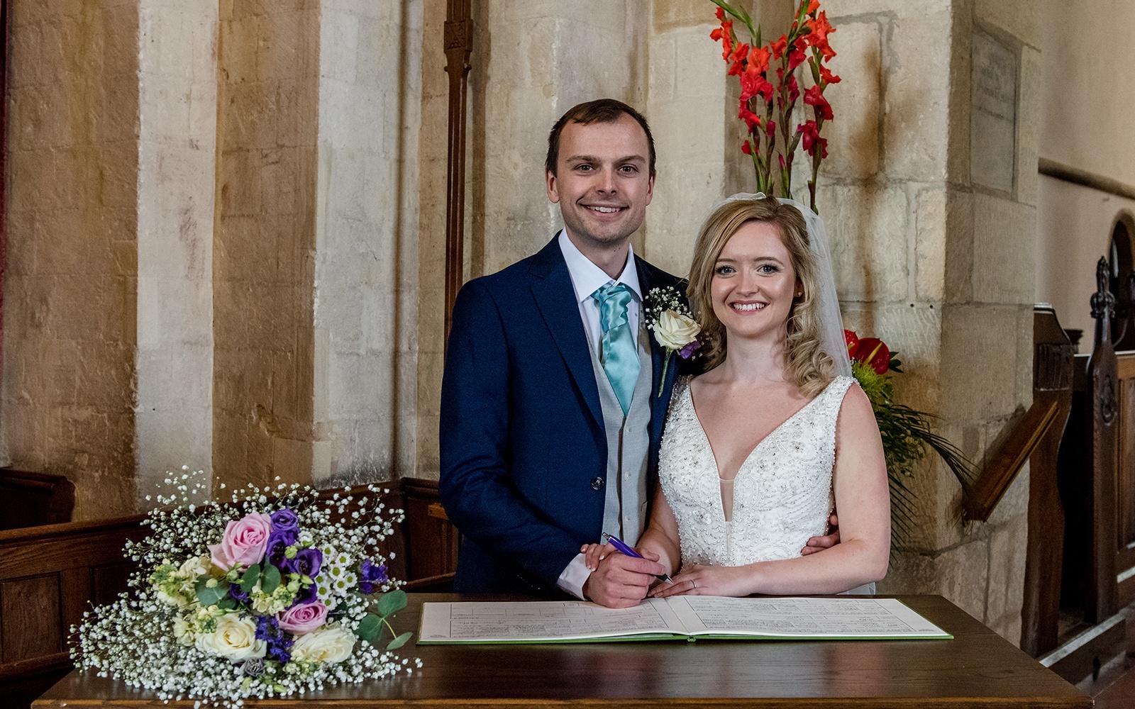 Capture Every Moment real wedding photography duo photographer Cirencester  Church of St Mary The Virgin Bampton Spittleborough Farm Wiltshire signing of the register bridal bouquet