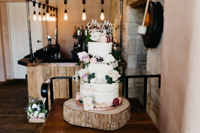 The Whitewed Directory from the professionals blog lets talk cake wedding suppliers cakemakers 3 tier semi nakes buttercream cake with real flowers macarons wooden log roll 